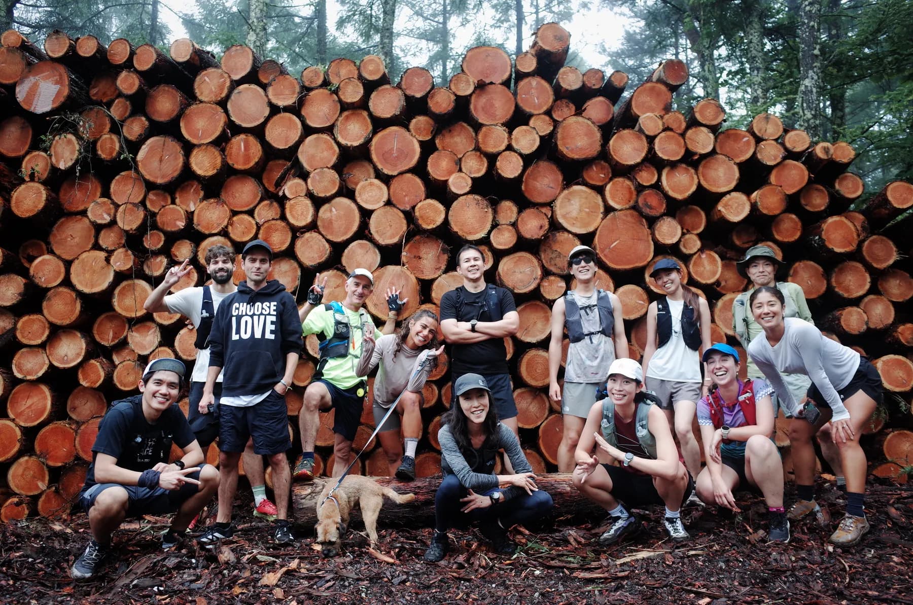 The group gathered by a woodpile